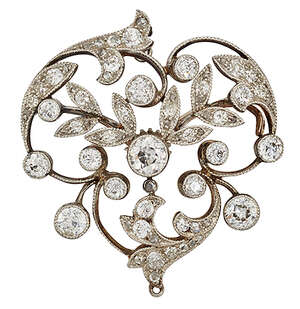 A late Victorian diamond cluster brooch, of scrolling foliate openwork design set with...