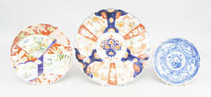 
	
		A Japanese porcelain plate, decorated with reserves of fan and rectangular shaped, filled...