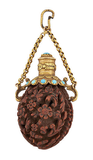 
	
		An early 19th century gold mounted, carved nut, turquoise miniature scent bottle, the nut...