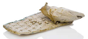 
	
		Colin Self, 
		British b.1941- 
		Bird on woven mat with seeds, 1972; 
		
		ceramic with...