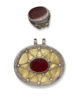 
	
		A Turkoman Tekke tribe ring and pendant, 20th century, the pendant of oval form, with...