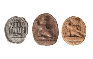 
	
		Three Tibetan terracotta votive plaques, 18th/19th century, one depicting Buddha seated,...