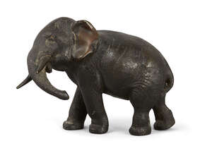 
	
		A small Japanese bronze elephant, Meiji Period, standing with head turned, 13cm high....