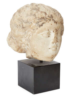 
	
		A marble female head
		After the Antique
		Her hair swept back from her forehead in...