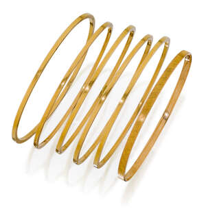 
	
		A group of six early 20th century gold bangles, including five of square section design...