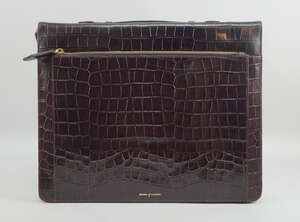 An Aspinal of London brown leather crocodile effect briefcase, with zip closure, suede and...