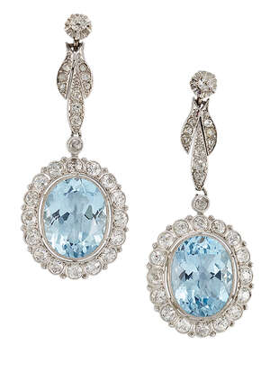 
	
		A pair of aquamarine and diamond drop earrings, each with collet-set oval mixed-cut...
