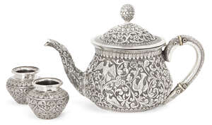 
	
		A silver repousse Kutch teapot, India, circa 1860 and two silver spice containers, of...