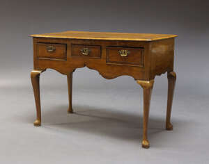 
	
		A George II style walnut lowboy, 20th Century, incorporating earlier elements, the...