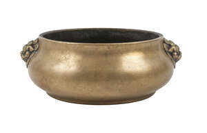 
	
		A Chinese polished bronze bombe censer, Xuande mark, 19th century, cast with lion mask...
