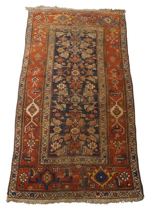 A Caucasian Kazak rug, first quarter 20th century, central geometric design, on a blue ground,...