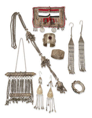 
	
		A group of silver jewellery, Saudi Arabia, 20th century, comprising a face cover, a...