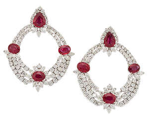 
	
		A pair of ruby and diamond earrings, each of flexible garland design, the top section...