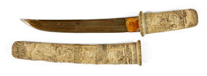 
	
		A Japanese carved ivory tanto, Meiji period, in slightly curved form, the scabbard and...