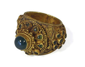 
	
		A Thai gold and filigree decorated floral ring, 19th century, set with green coloured...