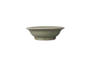 A Chinese Longquan grey stoneware celadon glazed dish, Ming dynasty, 15th century, the central reserve moulded with a flowerhead, unglazed ring to base, 12cm d