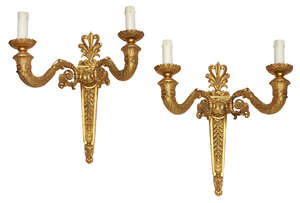 
	
		A pair of bronze and gilt bronze twin branch wall lights, 20th Century, designed with...