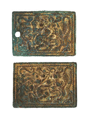 
	
		A pair of gilded bronze plaques, 3rd-1st century B.C., each cast in low relief with a...