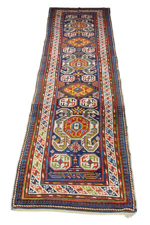 
	
		A Kazak runner, early 20th century, with octagonal medallions in a deep blue field with...
