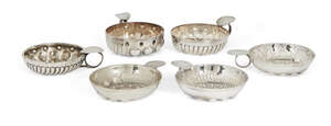 
	
		An unmarked white metal wine taster, together with a group of five silver plated...
