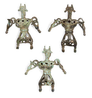 Three Amlash bronze openwork figures, 1st millennium B.C., standing their feet apart, horned and wearing belts around their openwork robes, each 7.5cm. (3)
		