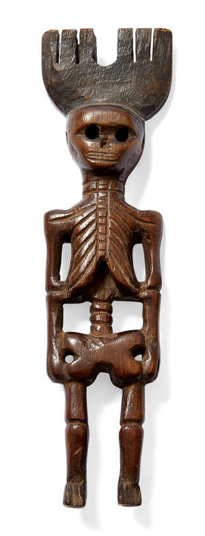 
	
		A Guatamalan carved wood slingshot, 19th century, carved as a skeleton, 19cm high 

	

