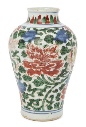 A Chinese porcelain wucai baluster vase, Ming dynasty, 17th century, painted with two Buddhist lions amid meandering flowering chrysanthemums, flat, unglazed b