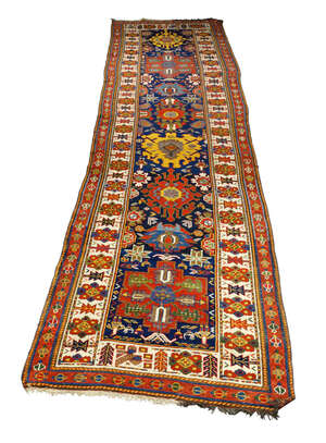 
	
		A Kazak runner, early 20th century, with eight medallions in an indigo field, the main...