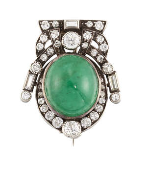 
	
		An emerald and diamond brooch, the oval cabochon emerald within an old brilliant,...
