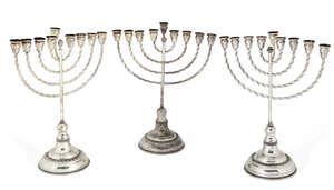 
	
		A pair of silver menorahs, by Hazorfim, stamped 925, each raised on a stepped circular...