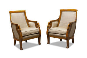 
	
		A pair of French Empire walnut bergère armchairs, early 19th century, the curved backs...