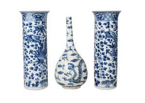 A Chinese porcelain bottle vase and a pair of sleeve vases, 19th century, the bottle vase painted with two confronting dragons amidst clouds and flames, 24cm h