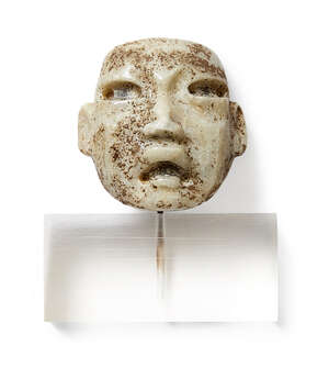 
	
		A carved stone Olmec-type mask, 4.5cm high, on perspex stand 

	

