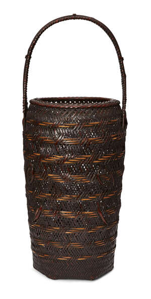 
	
		A Japanese tall Ikebana basket, early 20th century, of tubular form with woven handle,...