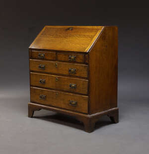 
	
		An oak bureau, early 20th Century, the fall enclosing an arrangement of pigeon holes and...