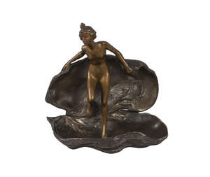 
	
		A French patinated and silvered bronze model of a maiden emerging from a shell, after...