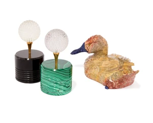 Two golf ball sculptures,&nbsp;each with a carved rock crystal quartz golf-ball atop a tee, the tee...