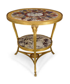 
	
		A gilt metal and specimen marble top two tier centre table, 20th century, the circular...