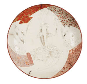 
	
		A large Japanese Kutani dish, Meiji period, decorated to the central reserve with a...
