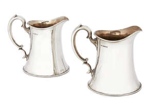 
	
		A pair of silver jugs, Sheffield c.1935, Frank Cobb & Co Ltd., of flared form with scroll...