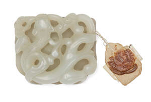 
	
		A Chinese pale green jade dragon buckle, 17th/18th century, finely carved as a chilong...