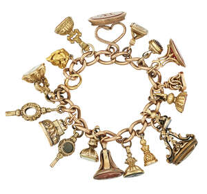 A 19th century gold bracelet suspending various fob seals, the curb-link bracelet with fifteen gold, gold cased and gilt fob seals, some mounted with various h