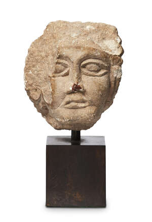
	
		An Eastern Roman carved stone head of a man, 3rd-5th century A.D., with delineated eyes,...