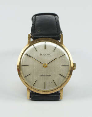 
	
		A 9ct. gold wristwatch, by Bulova, the circular silvered dial with applied baton markers...