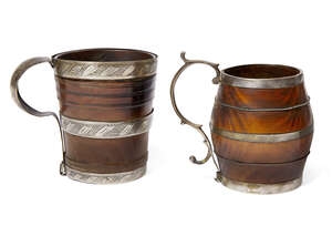 
	
		Two turned wood white metal mounted mugs, 18th/19th century, one of barrel form with 's'...