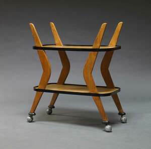 
	
		A two tier serving trolley, c.1950s, with two rounded rectangular trays on boomerang...