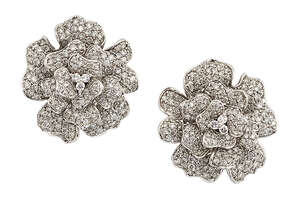 
	
		A pair of diamond earrings, of stylised floral design, the undulating petals inset with...