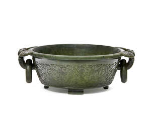 
	
		A Chinese spinach jade marriage bowl, Qianlong period, the sides with everted rim and...