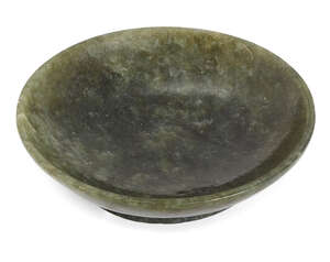 
	
		A Chinese spinach-green jade saucer dish, 19th century, with flattened rim and curving...