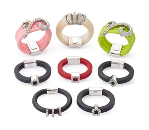 A group of eight rubber rings,&nbsp;in black, green, clear, red or pink rubber of square, round or D...